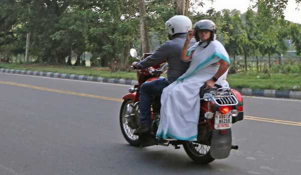 Banerjee rides pillion on motorcycle