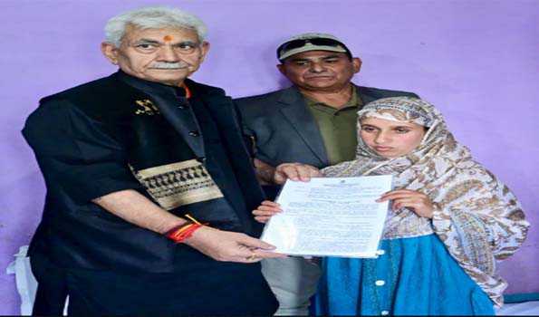 LG Sinha hands over job letter to braveheart Adil’s wife in Anantnag